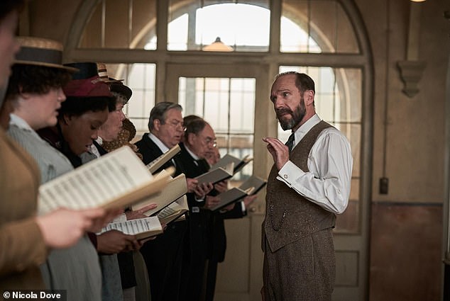 Roger Allam as Alderman Duxbury and Ralph Fiennes as Dr Guthrie, Amara Okereke as Mary, Alun Armstrong in The Choral