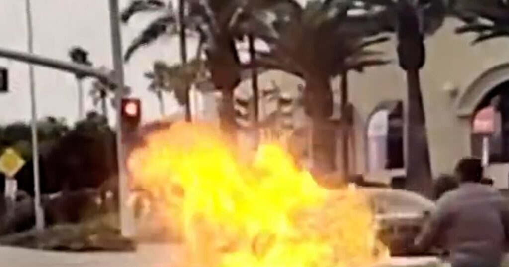 Dirt bike erupts in flames on camera after hitting car
