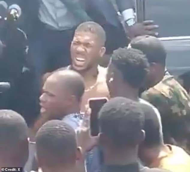 Anthony Joshua pictured after the car crash in Nigeria on Monday which killed two of his pals. The Champion boxer came within inches of death in the crash