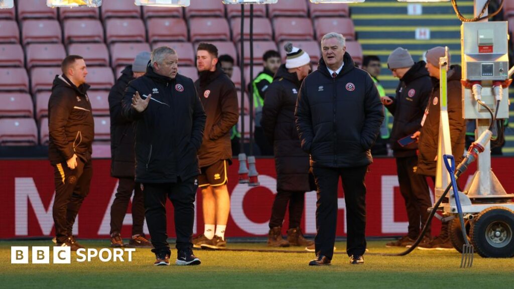 Sheffield United groundstaff inspect the pitch