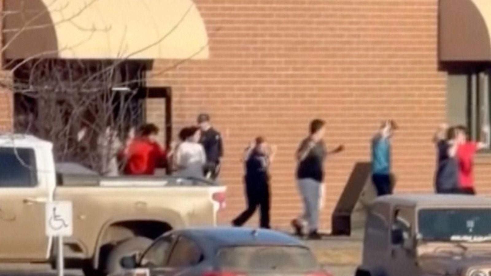 Footage shows students leaving their school with their arms in the air. Pic: AP