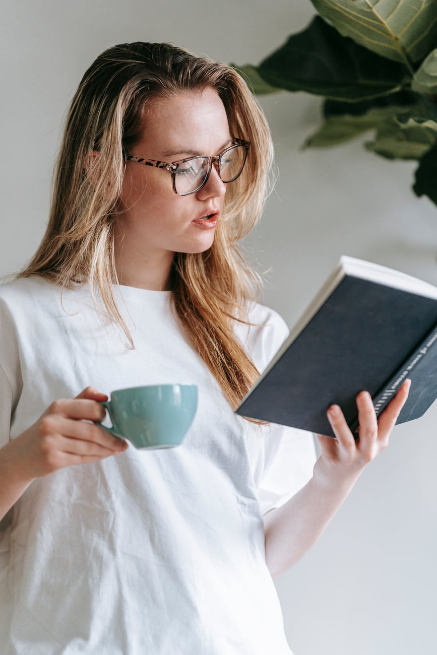 calm woman reading book in light room