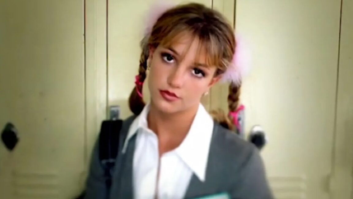 young schoolgirl in pigtails staring into the camera with head slightly tilted
