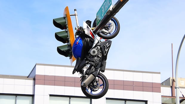 Motorcyclist seriously injured after crash leaves bike dangling from traffic light near Surrey-Delta border