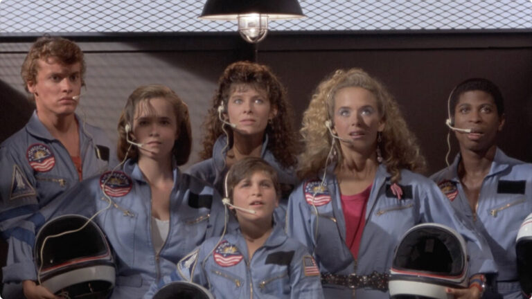 Still from SpaceCamp showing the cast about to board the shuttle