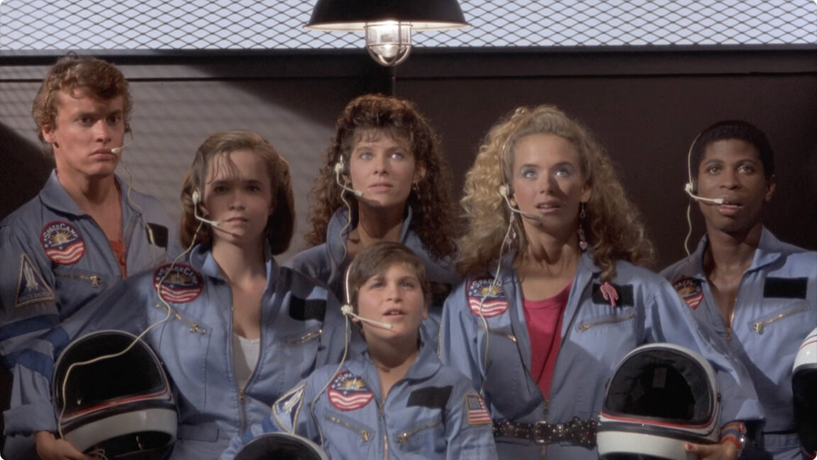 Still from SpaceCamp showing the cast about to board the shuttle