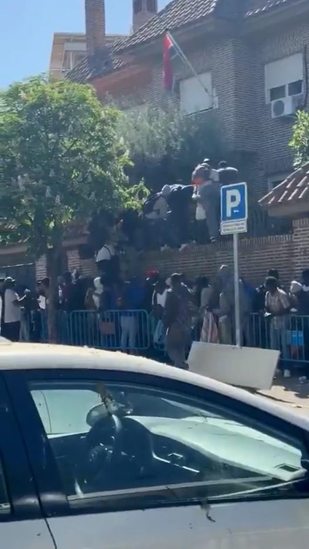 This is the image that shows the folly of Spain's socialist experiment to grant amnesty to 500,000 illegal migrants as dozens invade the Gambian Embassy in Madrid