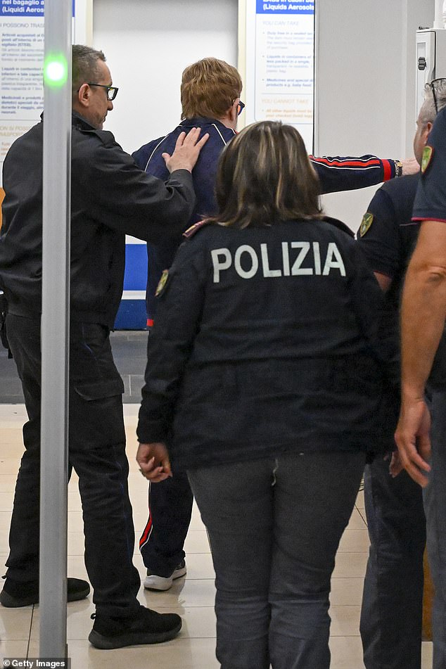 Music legend Sir Elton John was frisked by Italian police at the airport ahead of catching a private jet out of Sicily after performing at Dua Lipa and Callum Turner's wedding