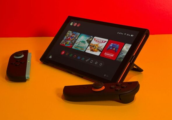 The Switch 2 standing up on a table with Joy-Cons detached.