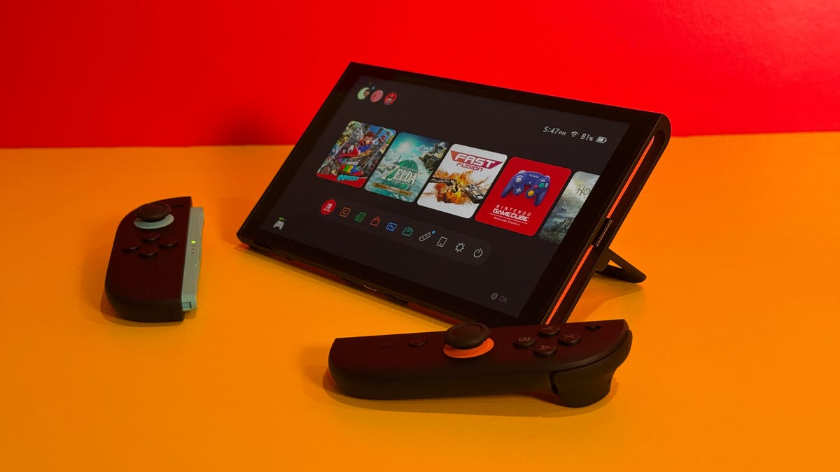 The Switch 2 standing up on a table with Joy-Cons detached.