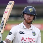 Ben Stokes, wearing a Durham batting helmet, raises his bat