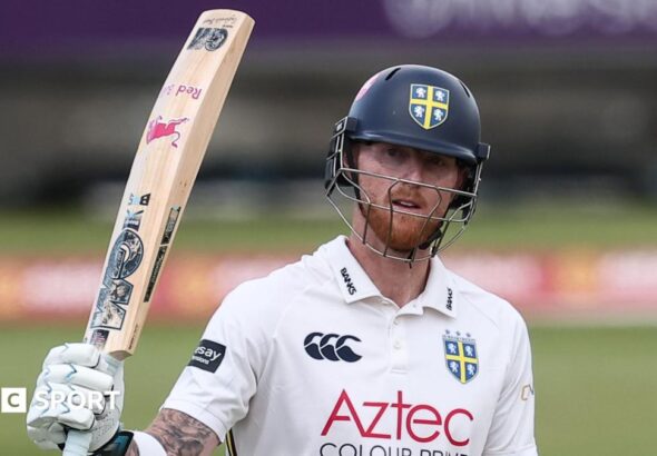Ben Stokes, wearing a Durham batting helmet, raises his bat