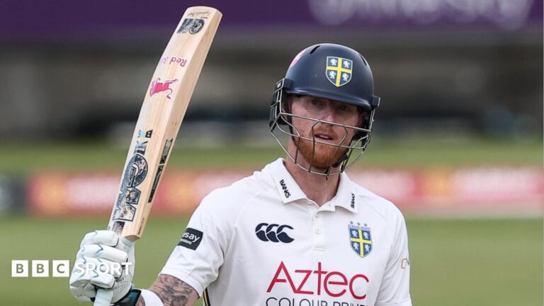 Ben Stokes, wearing a Durham batting helmet, raises his bat