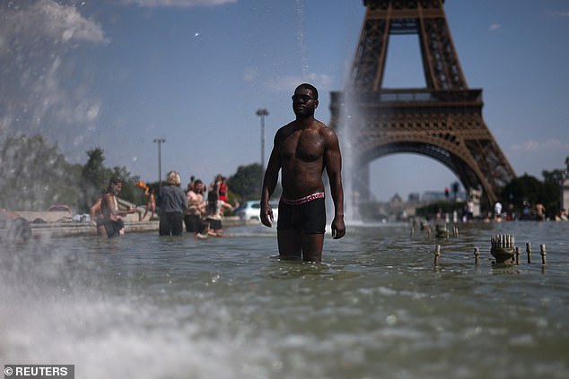 People cool off in the Trocadero Fountain near to the Eiffel Tower
