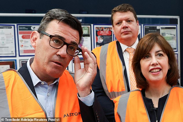 Andy Burnham, pictured with Education Secretary Lucy Powell, visited Alstom Transport in Derby on Tuesday as he pledged action to tackle Britain's youth unemployment crisis