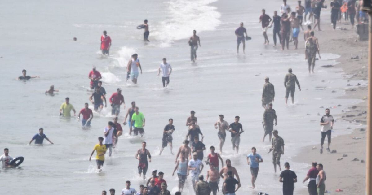 Chaos as thousands of migrants storm border into Spanish territory - police 'overwhelmed'
