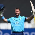 Ben Duckett raising his bat and helmet