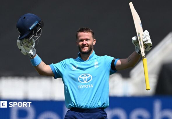 Ben Duckett raising his bat and helmet