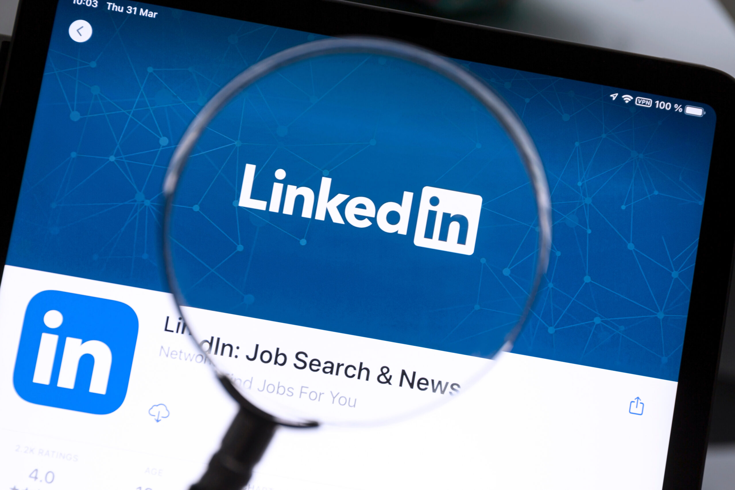 Linkedin logo under a magnifying glass