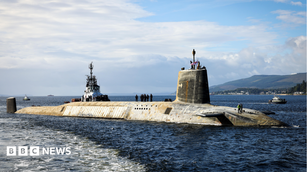 A shot of a Vanguard submarine half submerged in the water.