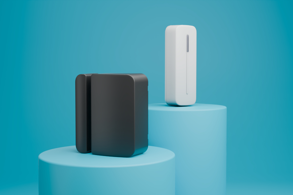 Two Abode sensor sit on blue pedestals.