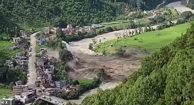 A wave erupts up across the bank of the Bhote Koshi River this morning in flash floods that have already claimed the lives of dozens