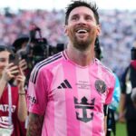 Lionel Messi smiles while cameras are focused on him