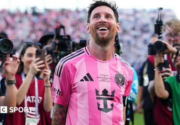 Lionel Messi smiles while cameras are focused on him