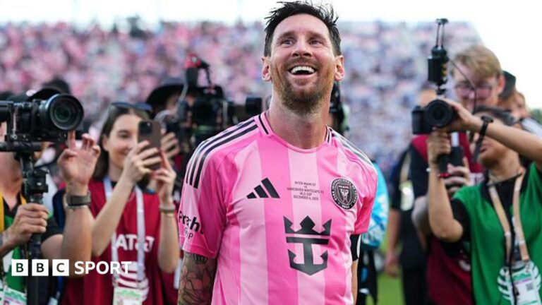 Lionel Messi smiles while cameras are focused on him