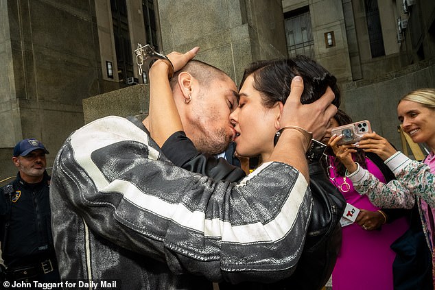 Angela Nikolau, 33, and Ivan Beerkus, 32, were seen in stylish leather jackets and matching handcuff bracelets before they locked lips outside of the Manhattan courthouse on Monday