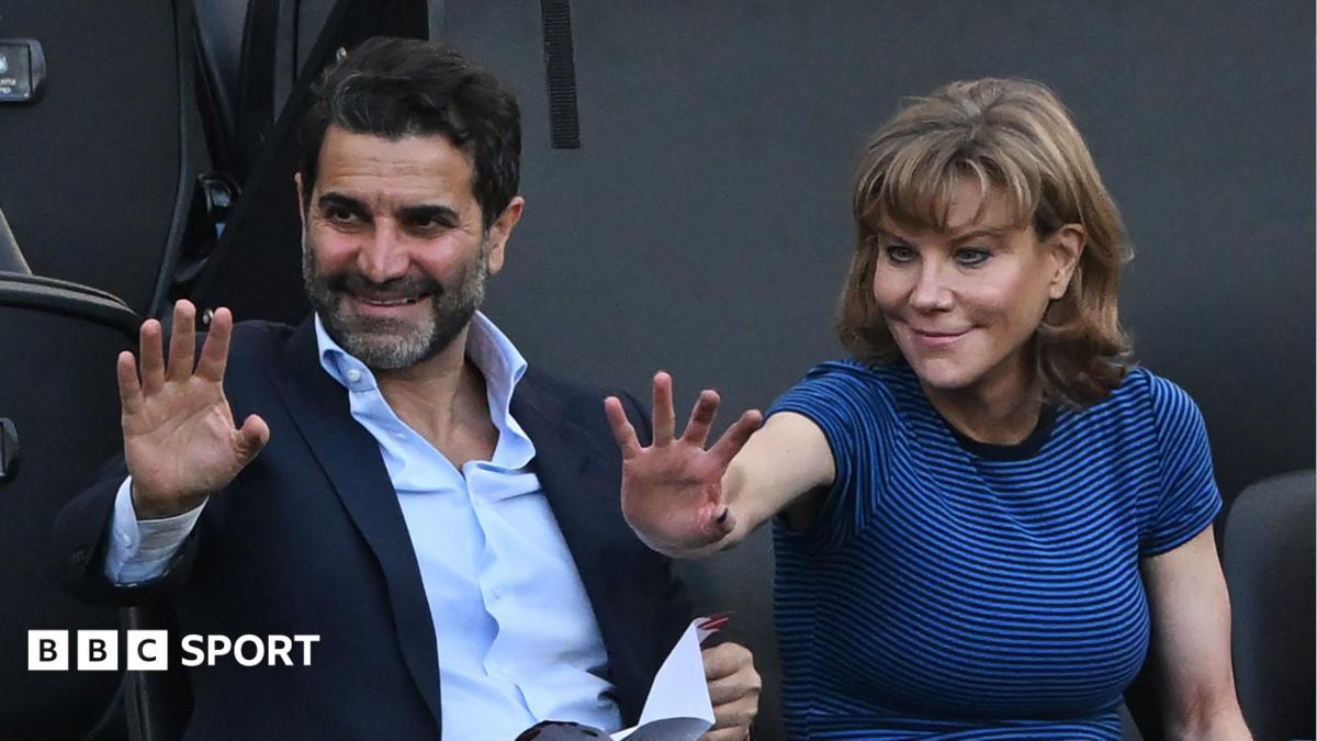 Former Newcastle United shareholders Mehrdad Ghodoussi (L) and Amanda Staveley wave from the directors' box