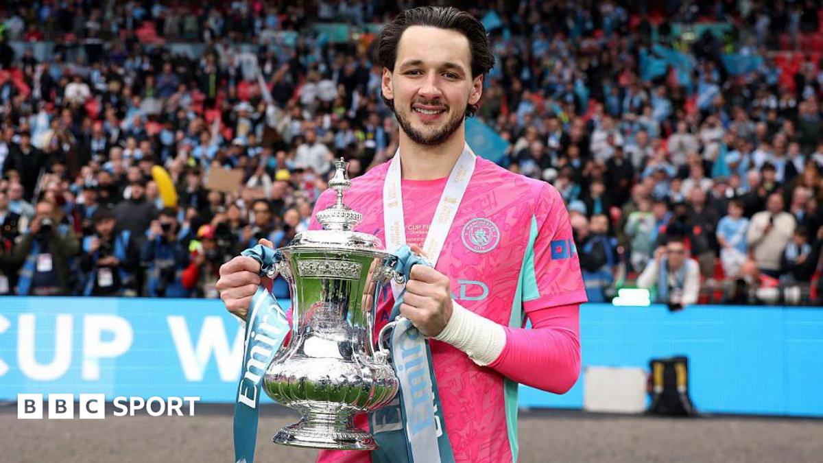 Manchester City goalkeeper James Trafford holding the FA Cup trophy at Wembley Stadium