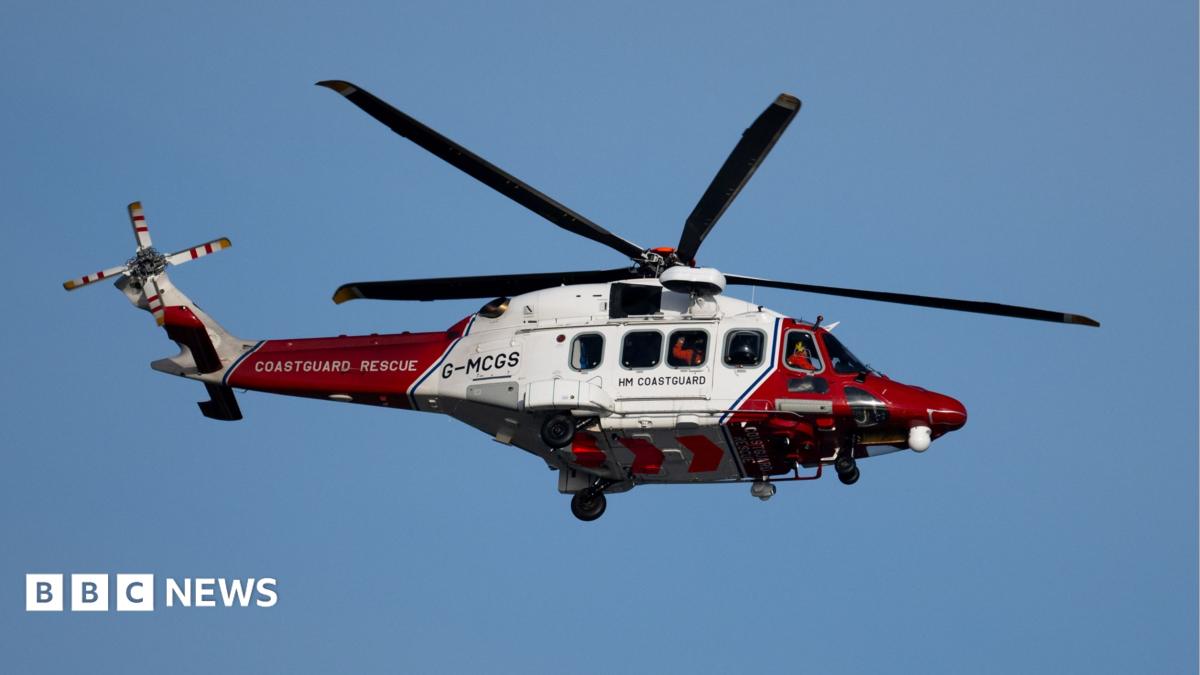 A coastguard helicopter in red and white livery