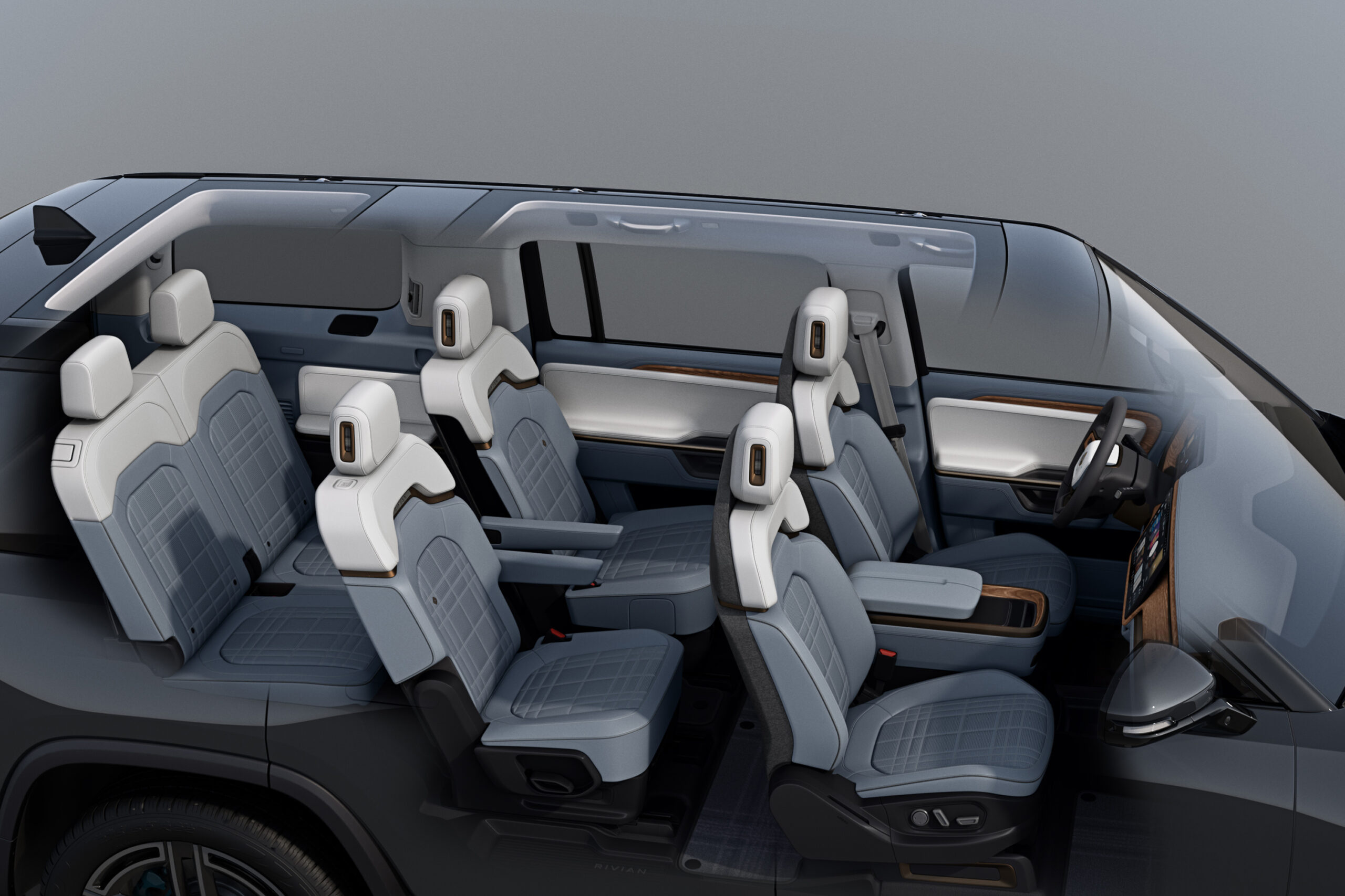 Render of Rivian R1S (2027) interior cut away to show the new second-row captain's chairs