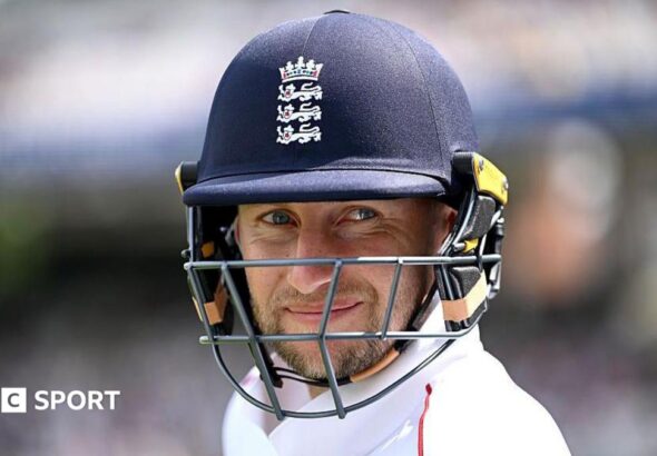 Joe Root smiles under his dark blue helmet