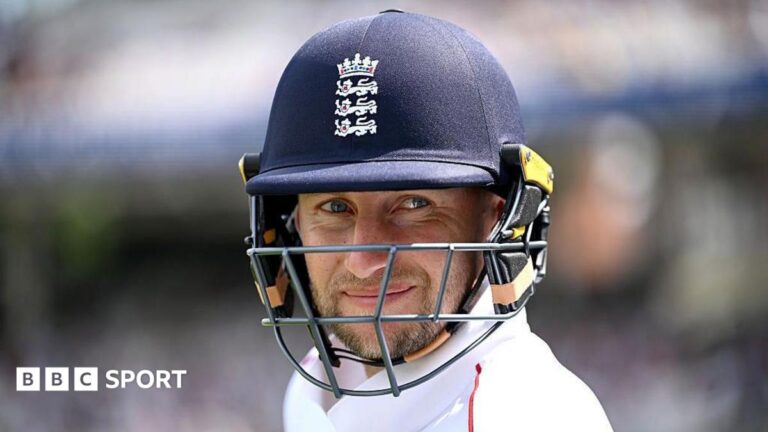 Joe Root smiles under his dark blue helmet