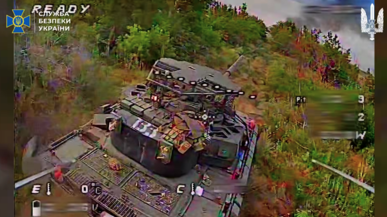 A screencap from a video posed by the Security Service of Ukraine shows the first-person view of a Ukrainian drone about to strike the rear of a Russian tank. The tank is apparently equipped with a new Arena-M active protection system intended to shoot down incoming drones and other munitions.
