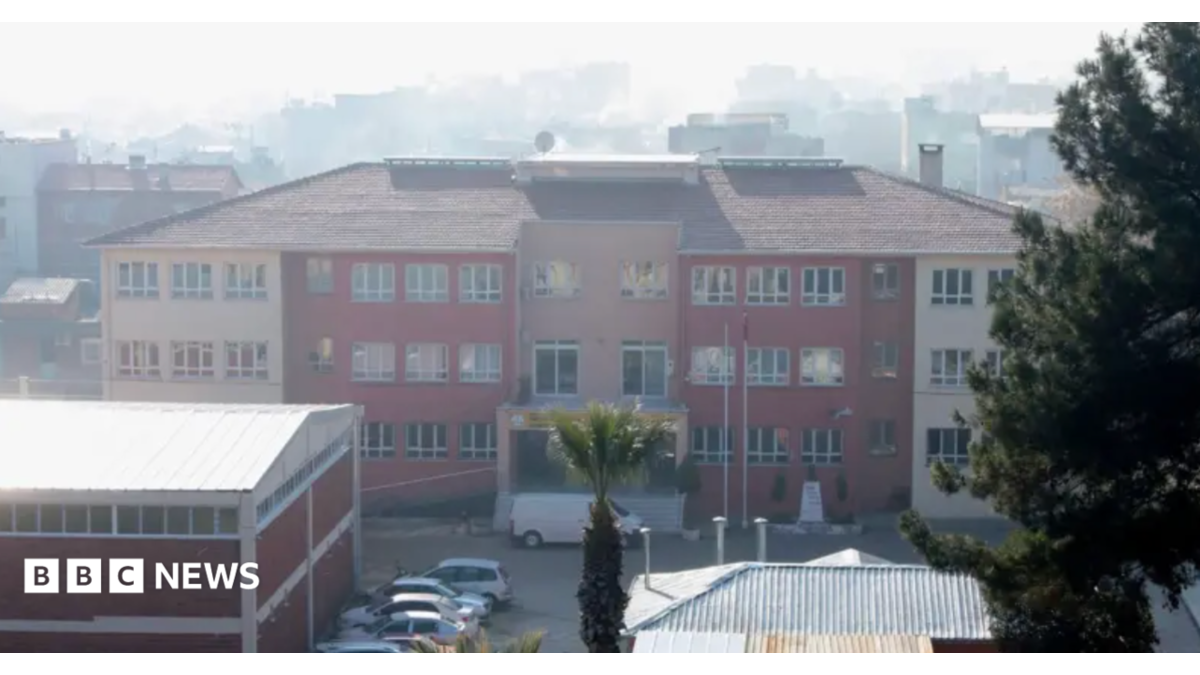 A photo of the school where the attack took place, taken in 2022 - it's a three story building that looks fairly modern but unremarkable - it has a mix of cream and red colouring and is seen from a middistance