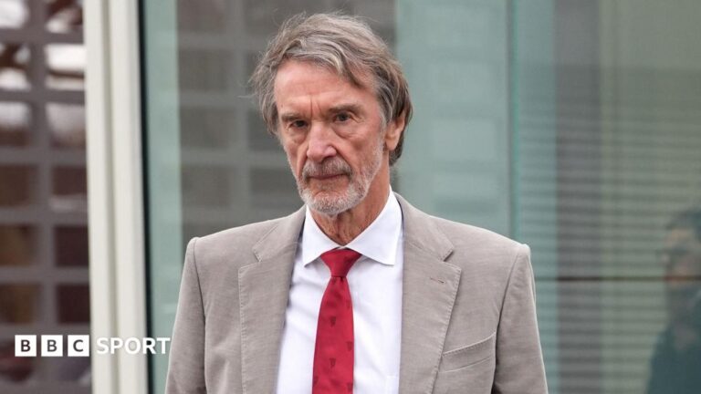 Sir Jim Ratcliffe in light-coloured smart jacket, white shirt and red tie