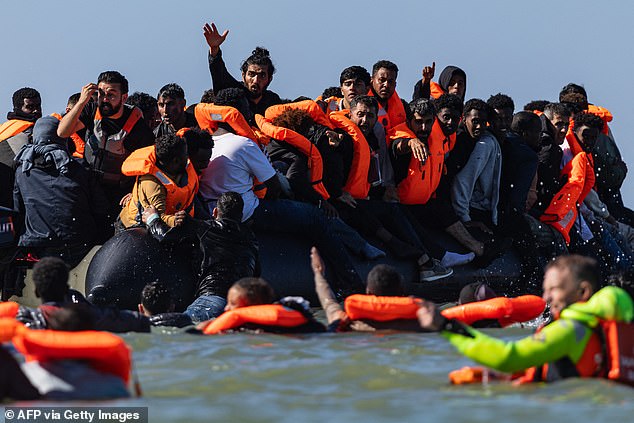 Migrants try to board a smuggler's boat off the beach of Equihen-Plage, northern France, last week