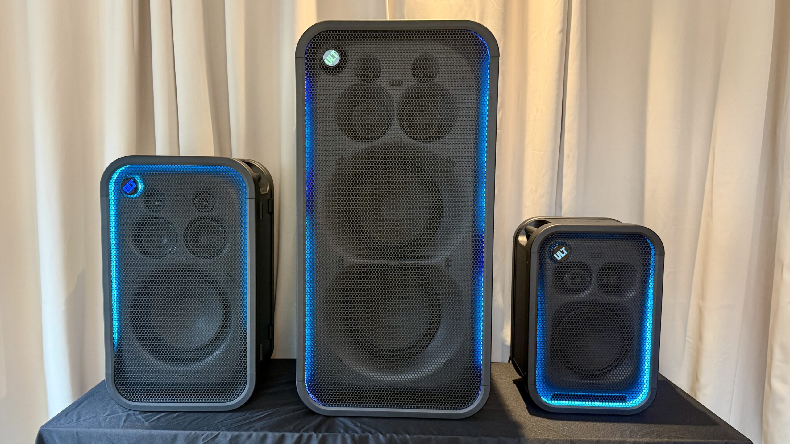 Sony's new ULT Tower Max flanked by the ULT Tower 5 and ULT Tower 7 with LED lighting surround the speakers edges.