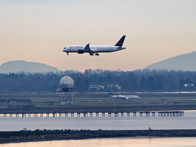 An Air Canada Boeing 787-9 Dreamliner jetliner airborne on approach for landing at Vancouver International Airport.