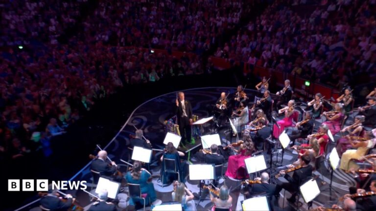 Orchestra playing as audience watch on.