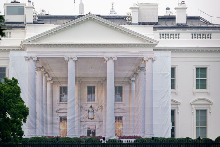 A protective tarp with a photo on it covers the scaffolding and the columns on the North Portico of the White House on July 18, 2026 in Washington, DC..