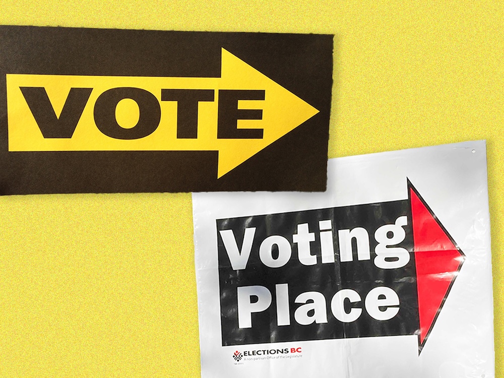 Two duelling voting place signs.