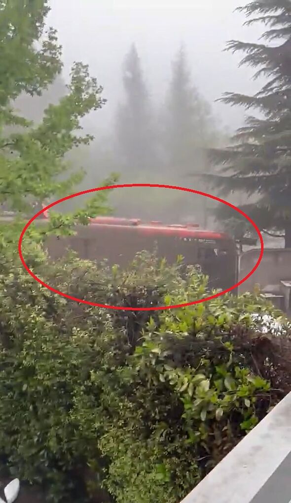 Harrowing moment bus is swept away by mud as terrified passengers cling to roof