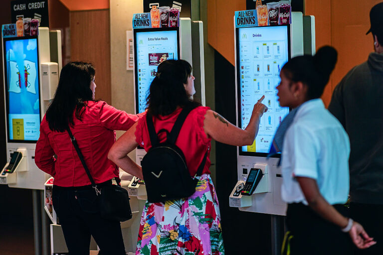 People look at a menu menu inside the McDonald's restaurant in Times Square, New York.