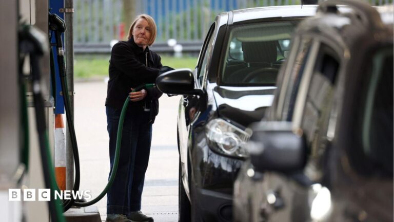 A woman fills her car up with diesel