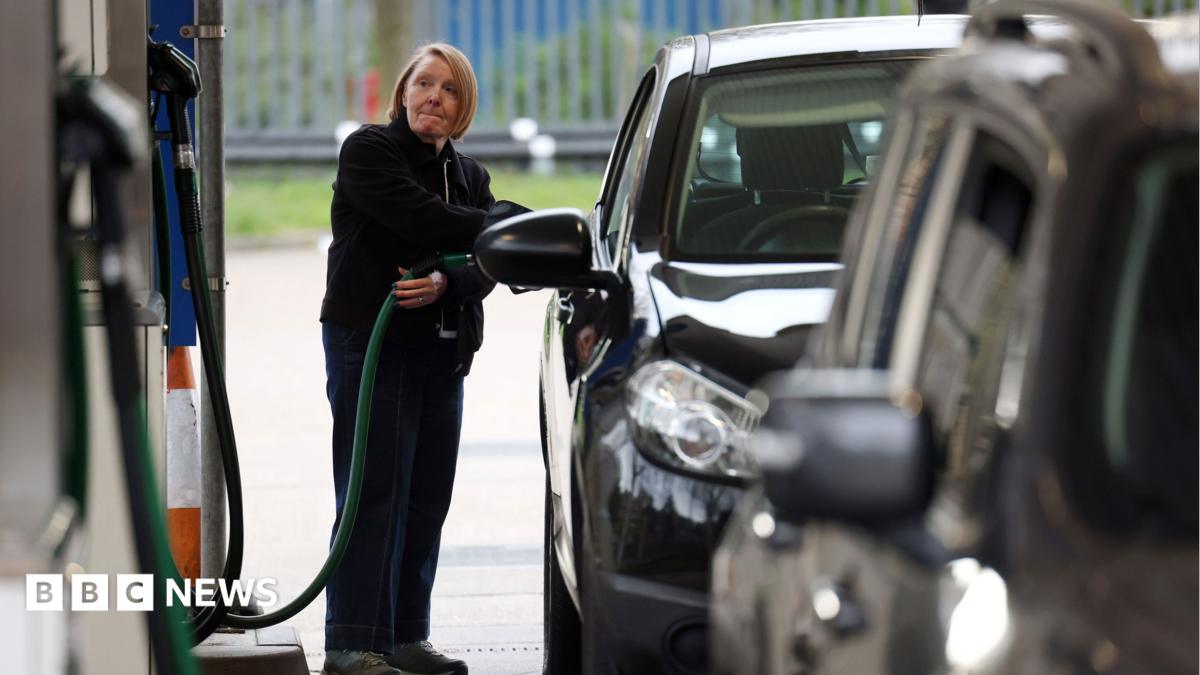 A woman fills her car up with diesel