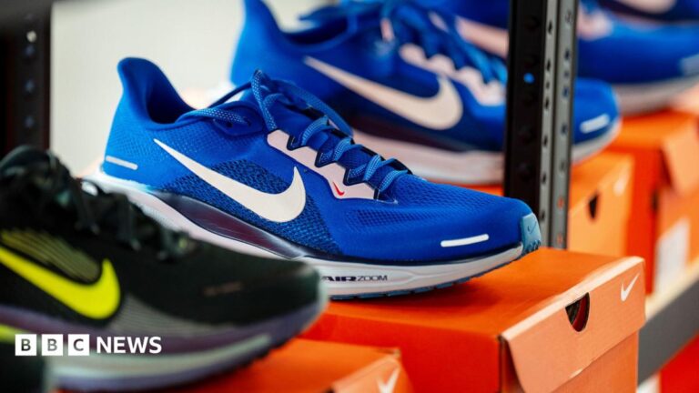 Nike trainers in a shop displayed on top of a Nike shoe box